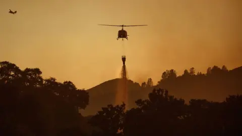 Getty Images Containment crews have been dropped fire retardant into the blazes