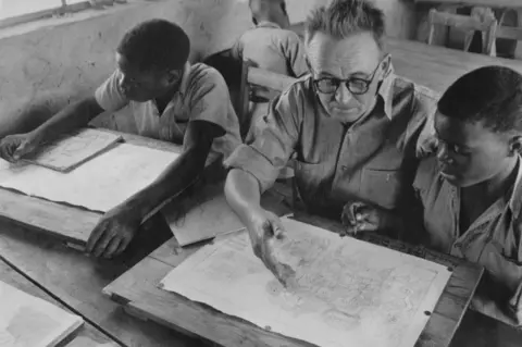 The Curtain Foundation Samuel Songo (R) and Canon Ned Paterson (M) at Cyrene Mission School