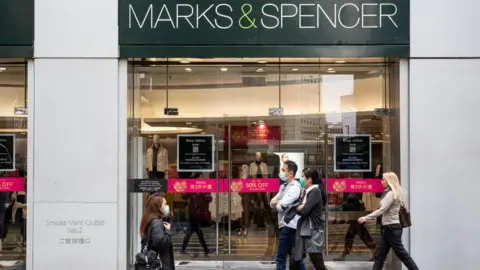 SOPA Images / Getty Images People walk past Marks & Spencer in Hong Kong