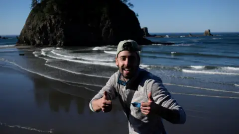 Matthew Dippel Matthew Dippel puts thumbs up on a beach