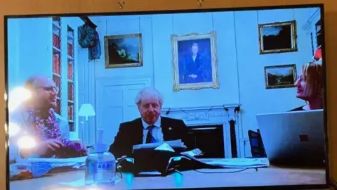 The Sunday Mirror A photo of Boris Johnson next to two other people in an office