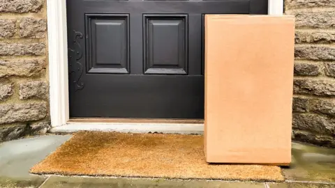 A parcel set against a door