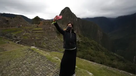 EPA A tourist takes a selfie at Machu Picchu