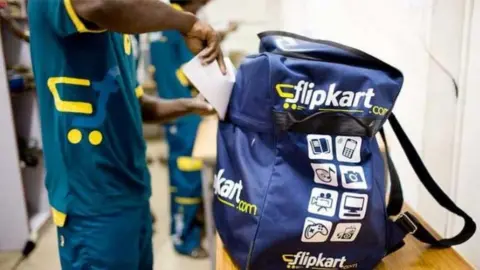 Reuters A delivery boy packs his Flipkart bag.