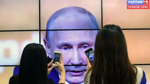 Getty Images President Putin on big screen, 2017 file pic