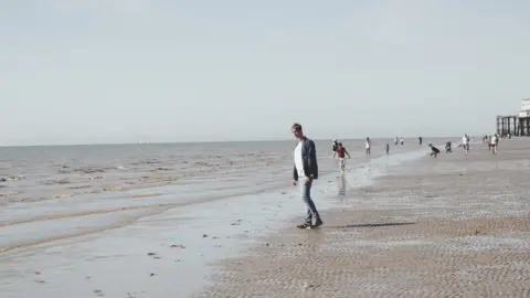 Christian Greenhalgh  Mark Newsome walking on the beach at Blackpool