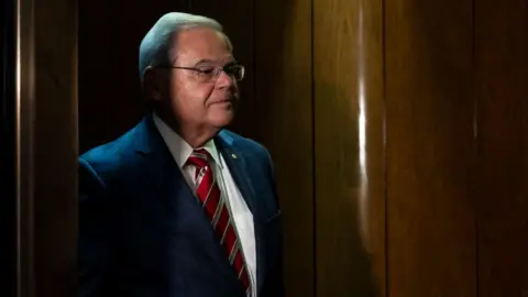 Bob Menendez stands in a Senate elevator