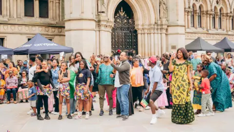 Bradford African Festival of Arts A group of people watching a performance outside Bradford City Hall