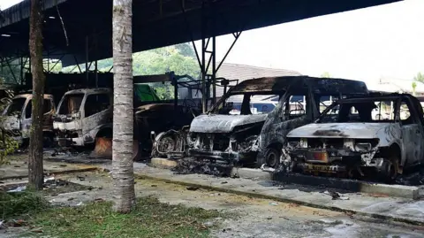AFP via Getty Images Charred vehicles are seen at the Bongor Subdistrict Administrative Organisation office in Ra-ngae district in the southern Thai province of Narathiwat 