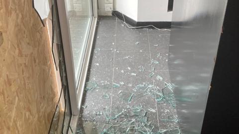 Smashed glass at Charlie Browns hair salon