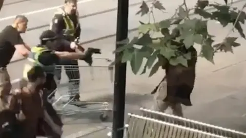 EPA Michael Rogers helps tackle the Melbourne attacker