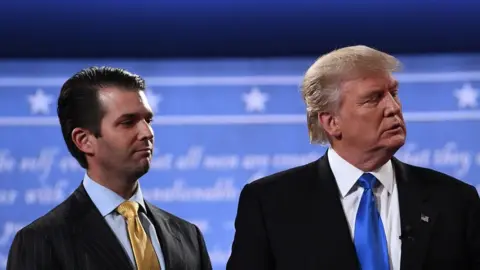 AFP Donald Trump Jr. stands onstage with his father Donald Trump after presidential debate in Hempstead, New York on 26 September 2016