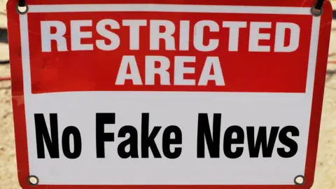 Getty Images A sign that says "Restricted Area, No Fake News"