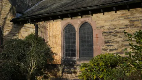 Oli Constable/BBC The window damage from the outside