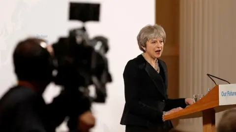 Getty Images Theresa May and a cameraman