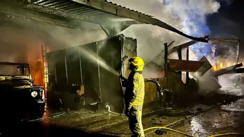 Maiden Newton Fire Station Fire fighter tackling blaze