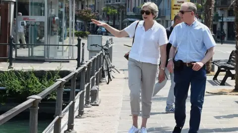 Reuters Theresa May and husband Philip in Italy