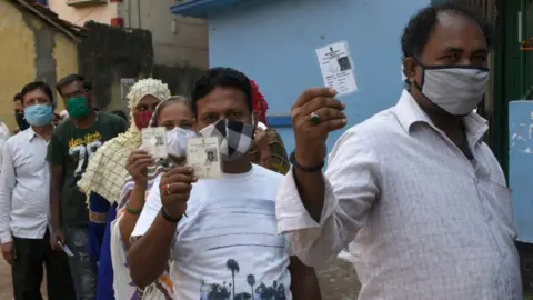 Getty Images Voters showing their Voter Identity Cards before enter the Polling Booth at Kolkata