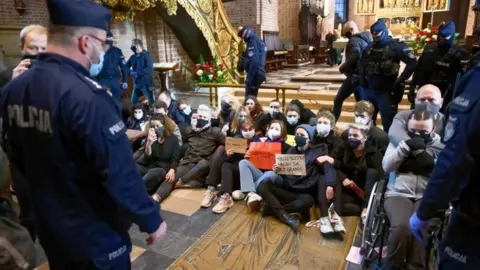 EPA Protesters stage a sit-in at the Archcathedral Basilica of St Peter and St Paul in Poznan, Poland