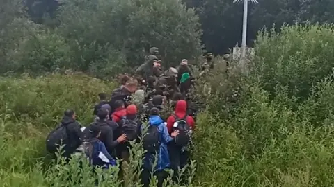 DPK.GOV.BY A video showing migrants trying to enter Lithuanian territory as border guards push them back