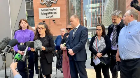 BBC Families of the victims outside the court