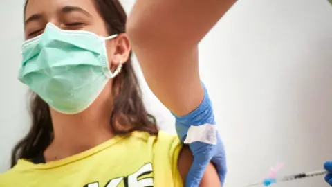 Getty Images Teenager in Spain receiving the Covid vaccine