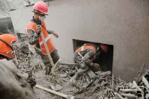 Reuters Soldiers inspect an area affected by the eruption of the Fuego volcano