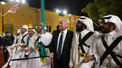 MANDEL NGAN/AFP via Getty Images President Donald Trump joins dancers with swords at a welcome ceremony ahead of a banquet at the Murabba Palace in Riyadh on 20 May 2017