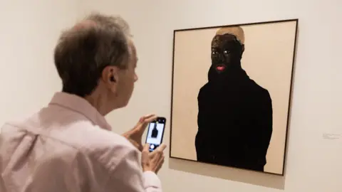EPA A guest looks at the painting by Ghanaian artist Amoako Boafo entitled "Hudson Burk 1" at the Hammer Museum in Los Angeles, California, the US - Friday 24 March 2023