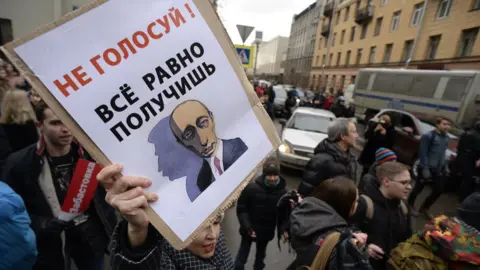 OLGA MALTSEVA A man holds up a placard at a rally in Moscow calling for a boycott of the Russian presidential election.