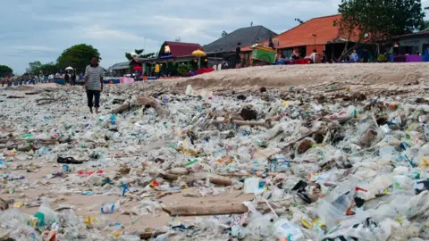 Getty Images Rubbish washed up on a beach in Bali