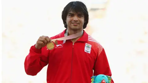 Getty Images Gold medalist Neeraj Chopra of India celebrates during the medal ceremony for the men's Javelin during athletics on day 10 of the Gold Coast 2018 Commonwealth Games at Carrara Stadium on April 14, 2018 on the Gold Coast, Australia