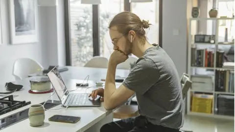 Generic image of man working from home