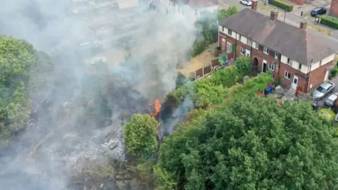 Christopher Furlong Last July firefighters fought a wildfire that encroached on nearby homes in the Shiregreen area of Sheffield