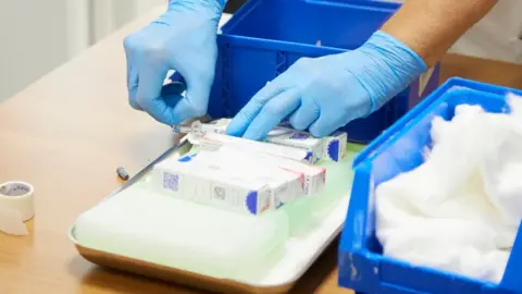 Getty Images Flu vaccine boxes