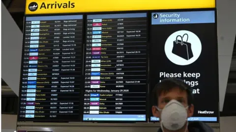 Getty Images Man wearing mask at Heathrow