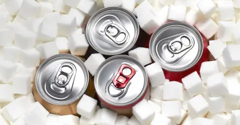 Getty Images Cans of sugary soft drinks