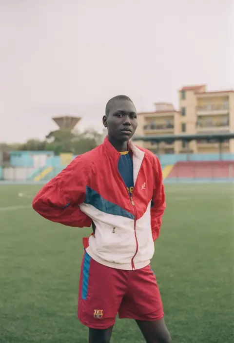 Jasper Fry A boy wearing a tracksuit in a stadium