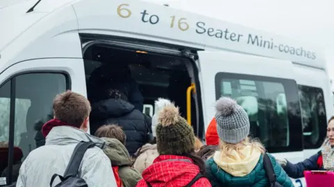 Getty Images Stock photo of children boarding a mini-bus