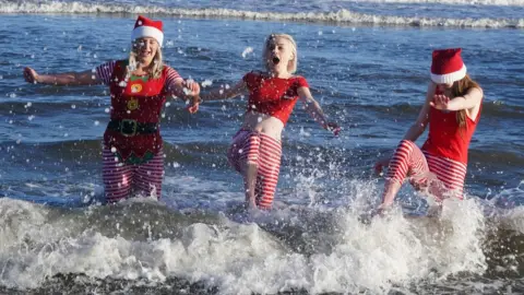 PA/Owen Humphreys Dippers dressed in festive fancy dress in Tynemouth