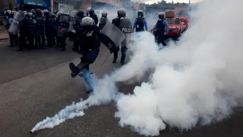 Reuters A riot policeman kicks a tear gas canister to demonstrators, during a protest against the re-election of Honduras" President Juan Orlando Hernandez in Tegucigalpa Honduras January 20, 2018.