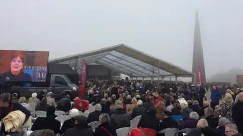 People sitting in an open-air auditorium