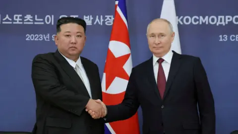 Russia's President Vladimir Putin and North Korea's leader Kim Jong Un shake hands in a meeting in eastern Russia in September 2023