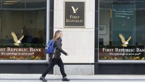 A pedestrian walks past a branch of First Republic Bank in Boston, Massachusetts, USA.