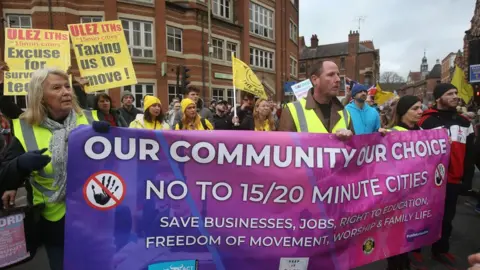 Getty Images Protesters march across the city behind a large banner on February 18, 2023 in Oxford, England