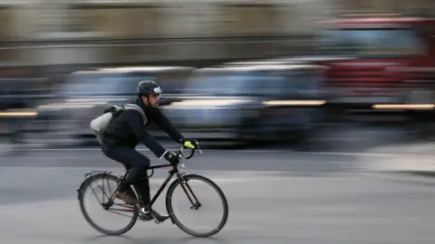 Reuters A Commuter cycles in central London November 15, 2013.