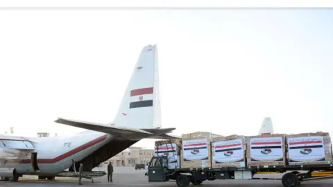 EPA A handout photo from the Egyptian Defence Ministry shows aid supplies being loaded into an Egyptian Air Force plane to assist Libya after devastating floods