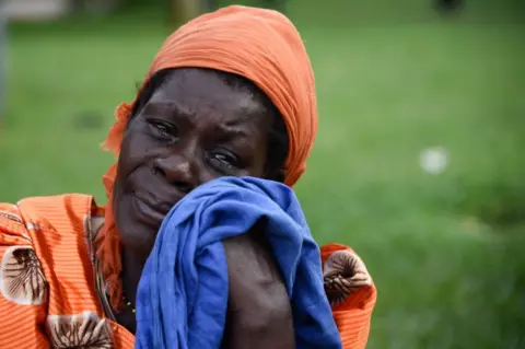 AFP A woman sheds tears at the rescue site of capsized cruise boat on Lake Victoria at Mutima village, Uganda - 26 November 2018