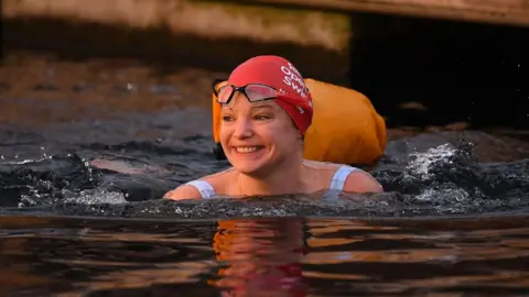 Justin Tallis/Getty Images Woman swimming in the West Reservoir Lake in East London