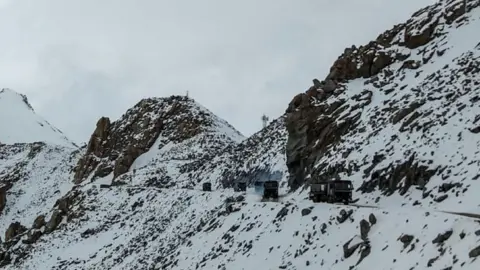 STR Indian Army vehicles drive on a road near Chang La high mountain pass in northern India's Ladakh region of Jammu and Kashmir state near the border with China on June 17, 2020.